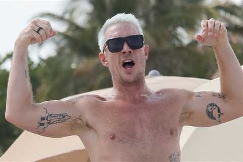 Diplo flexes his muscles on a beach day in Miami